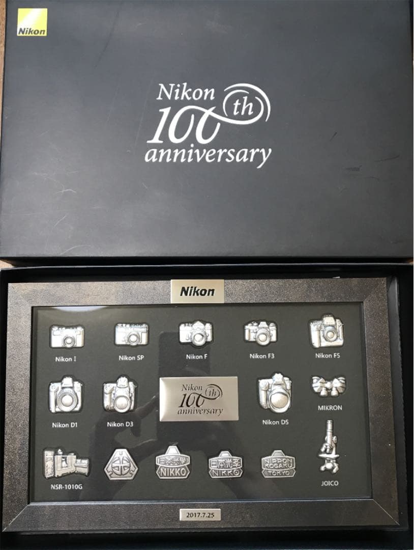 Nikon100周年記念カメラモデルバッジ - メルカリ