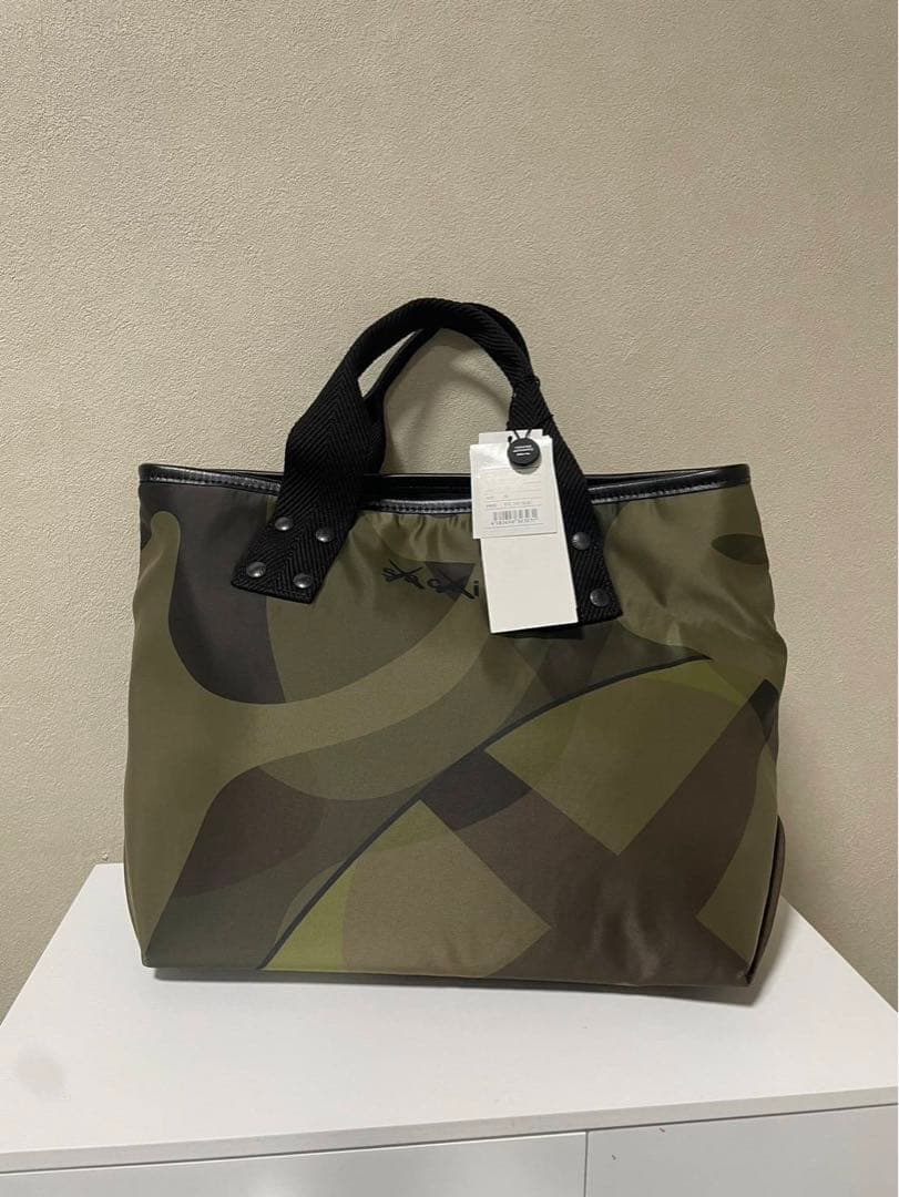 週末値下げ新品未使用sacai KAWS Bag \"Camo\"